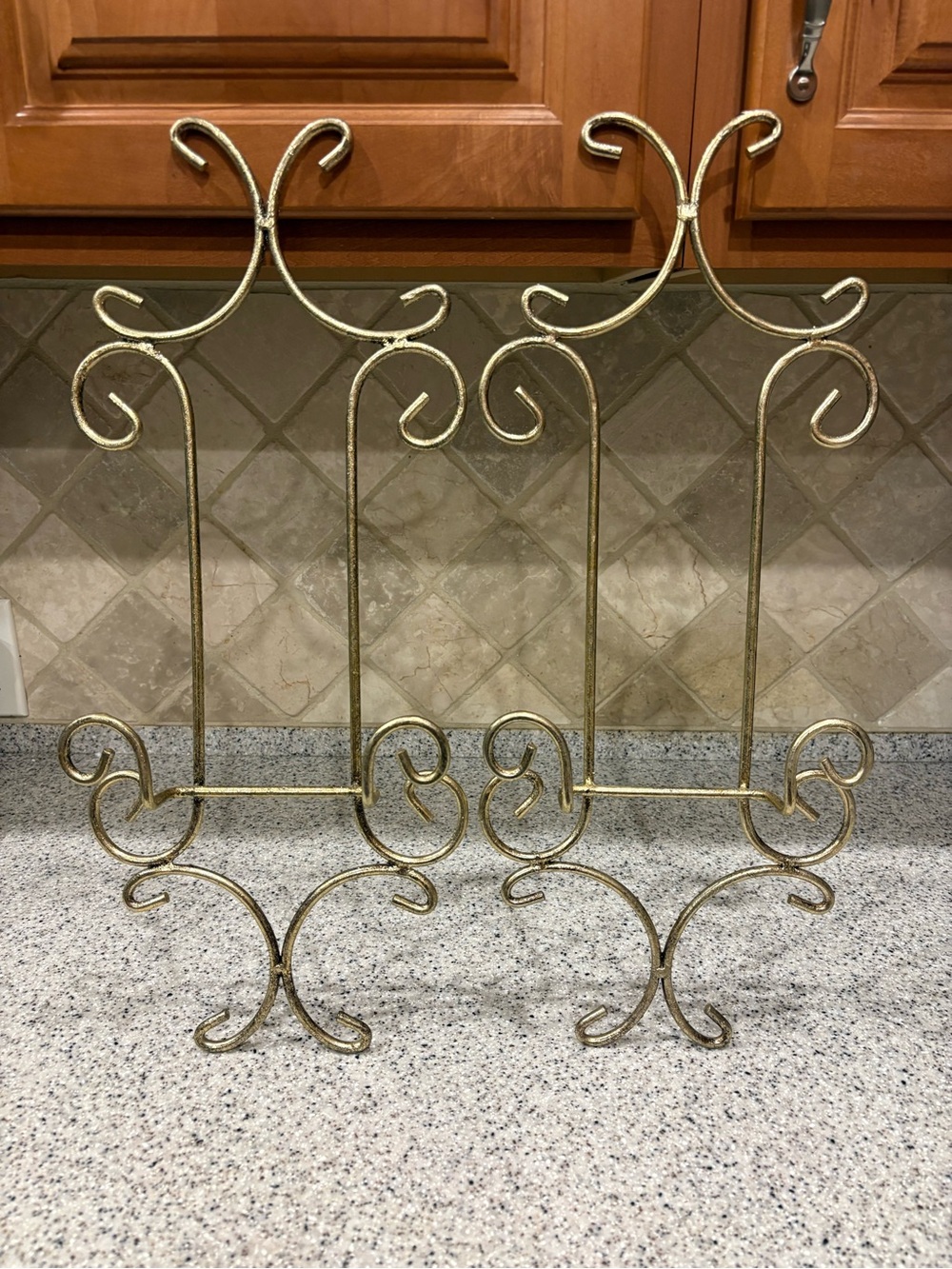 Two gold metal scrollwork freestanding display easel stands plates, books,frames